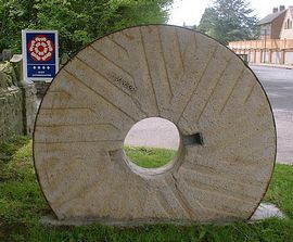 Millstone marking entrance to Burcott Mill 